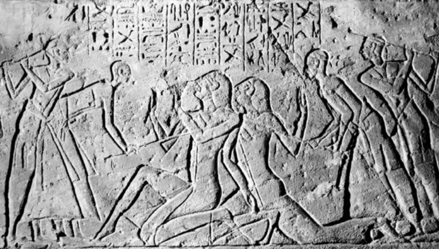 Ancient carving Shasu spies being beaten by Egyptians